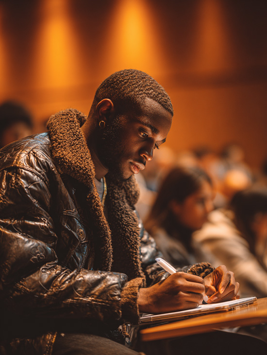A male student using an iPad 7 for note taking.