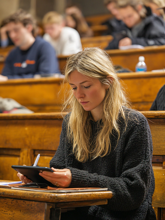 A student at university using an iPad in a lecture