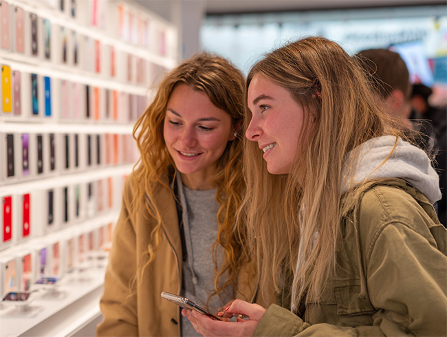 Two girls shopping for a new iPhone 17 case
